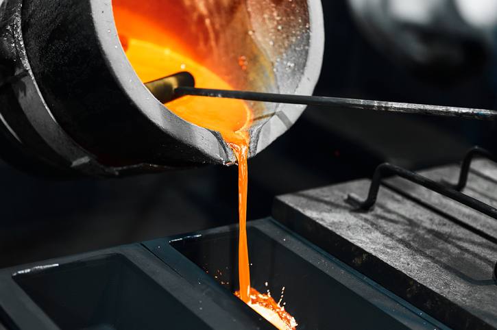 pouring hot metal into a graphite mold